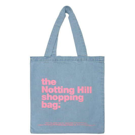 A notting hill shopping bag, in basic denim, light blue, with pink writing