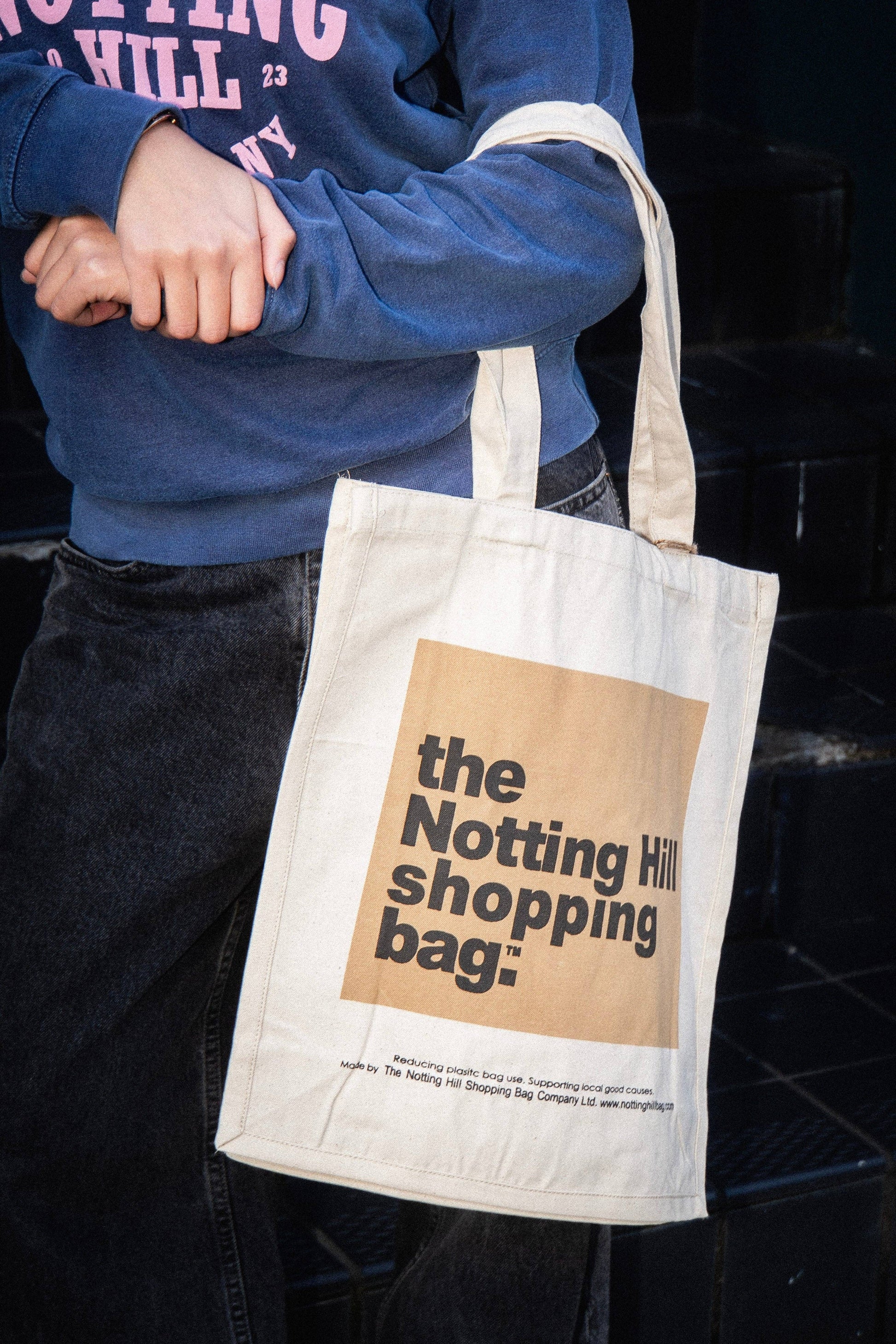 A person holding a Beige Notting Hill Shopping Bag in the Colour block range