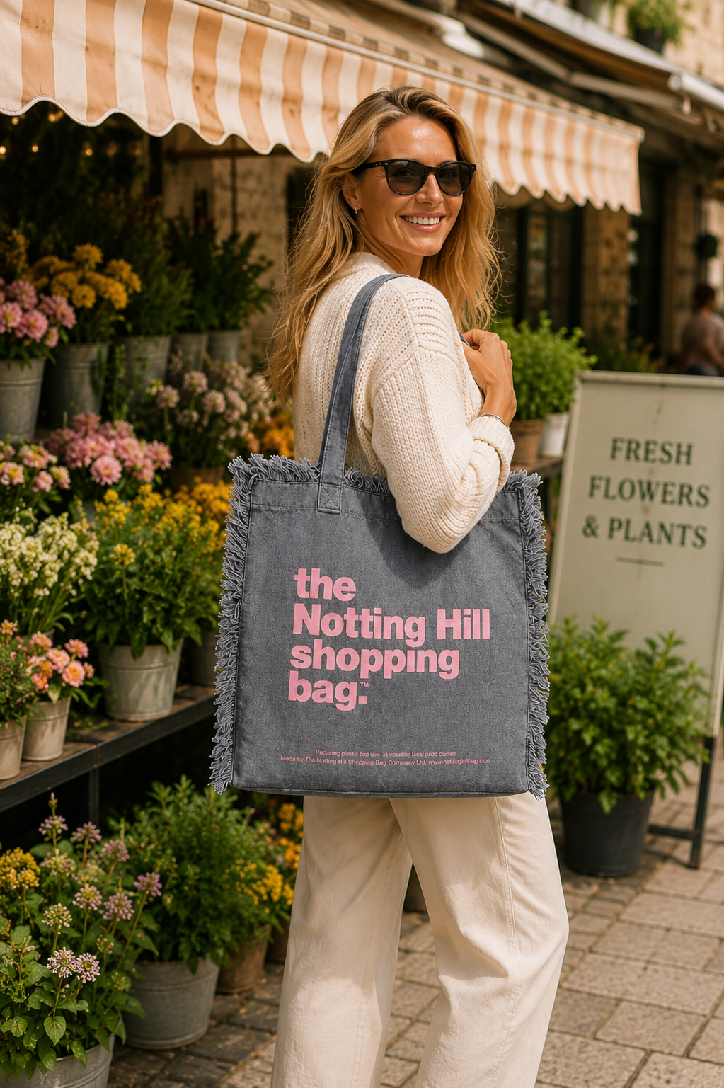 A woman carrying a Grey, Freyed Notting Hill Shopping Bag, at a flower market