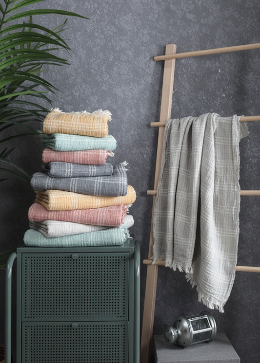 Hera Peshtemal towel stack on a cabinet with a towel rack 