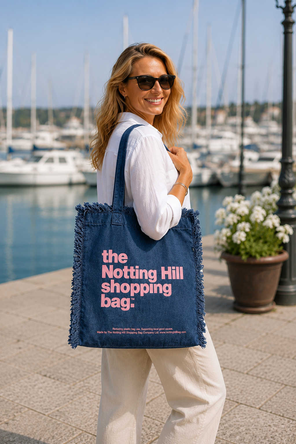a woman holding a Navy, Freyed Notting Hill Shopping Bag, near a pier