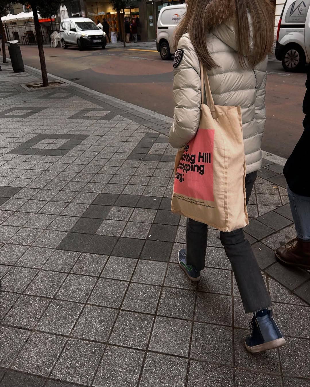 a woman carrying a Notting Hill Shopping Bag, Pink Colour Block range, walking on a street in London