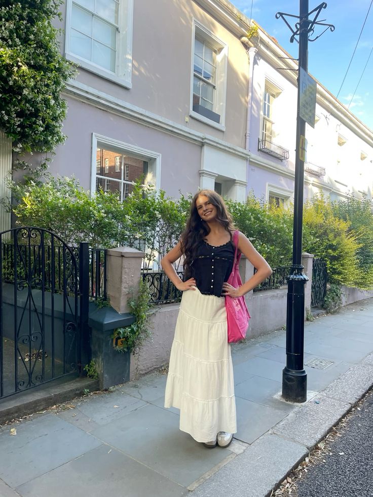 A girl on a London street, holding a Notting Hill shopping bag hand dye collection bag, in Pink with Pink logo