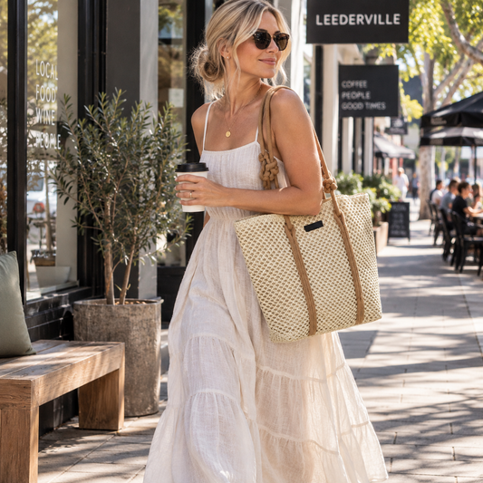 Our global finds Rope Handle Woven Bag, shopper style in natural beige material with tan rope handles, being carried by woman in a cafe strip. available in Australia and with free delivery