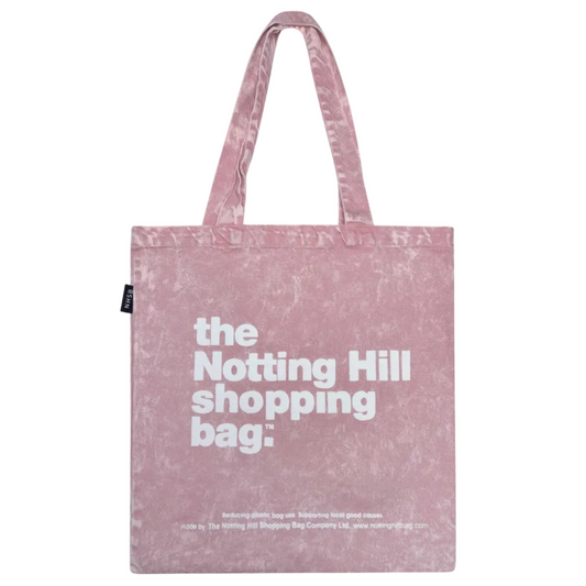 Pink tote bag with 'the Notting Hill shopping bag' text on a white background